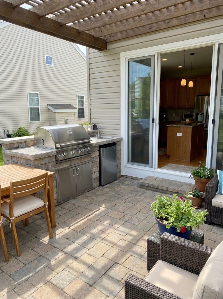 Outdoor kitchen located near indoor kitchen for easy access and better workflow
