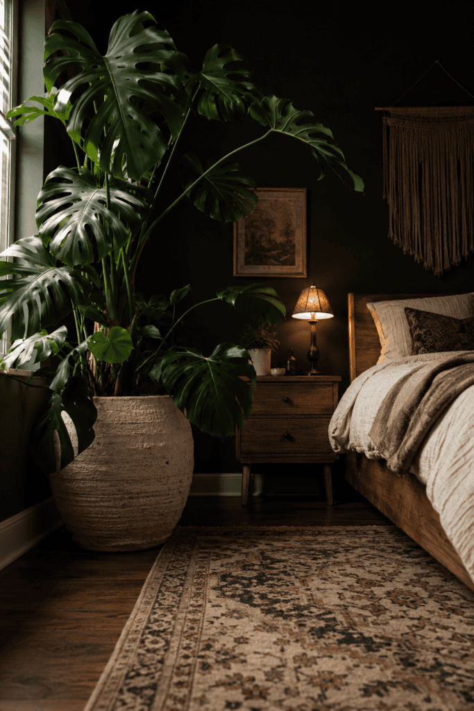 Dark boho bedroom with large indoor plant, moody walls, and cozy botanical bedroom inspiration